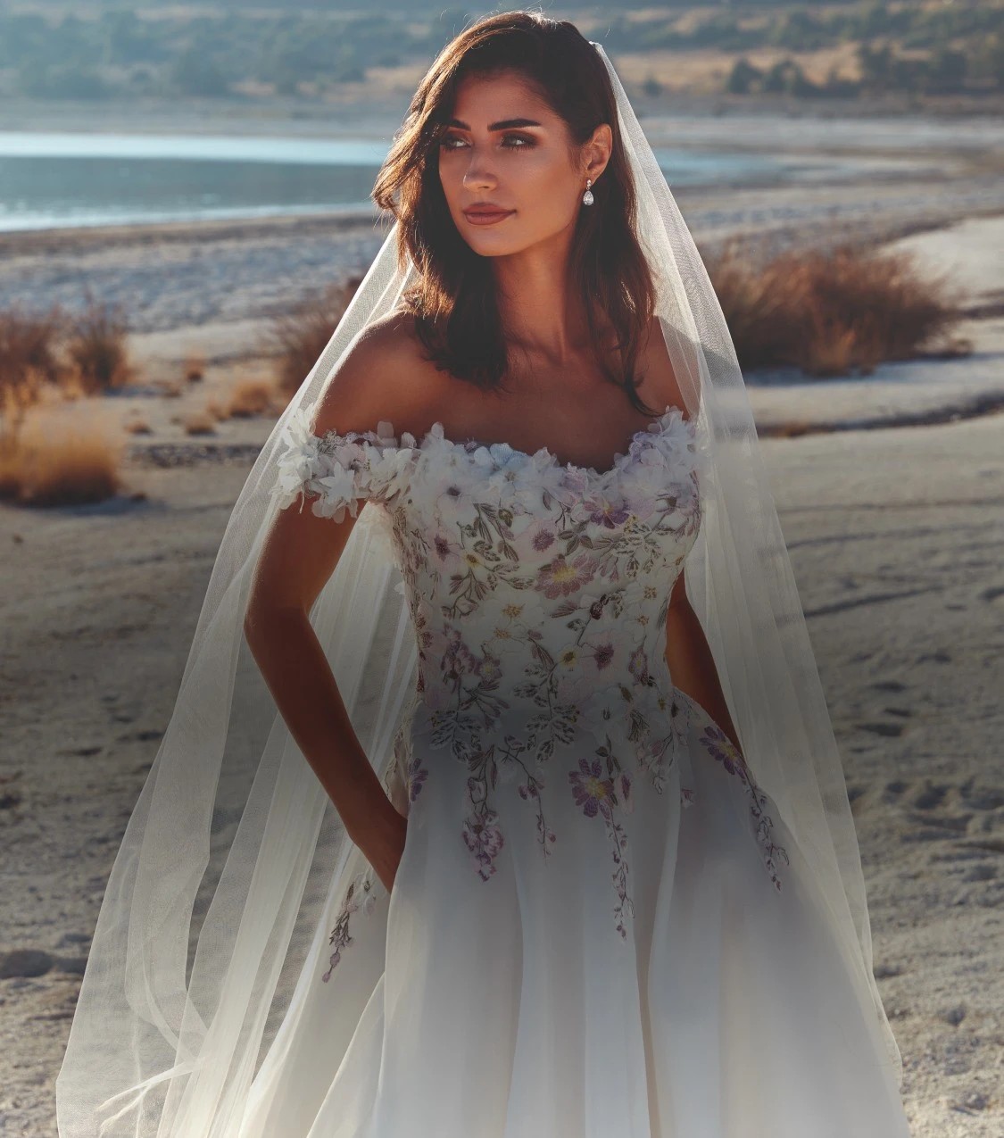 A Model wearing a white gown on the beach Mobile